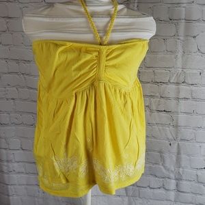 Yellow sleeveless shirt with white embroidery